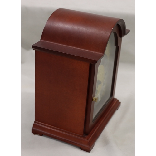 4088 - A Hermle reproduction mahogany mantel clock, 25cm high.