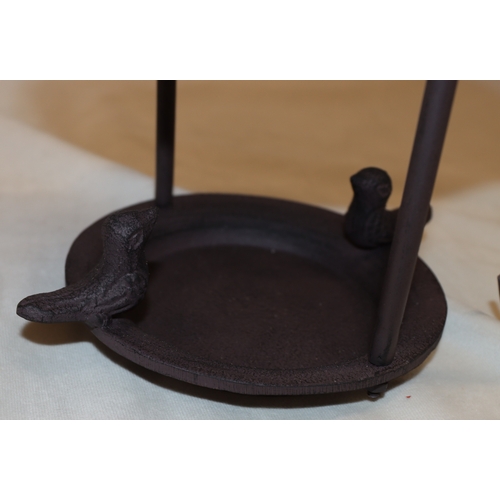 4101 - A pair of bird feeders with copper tops, 29cm high.