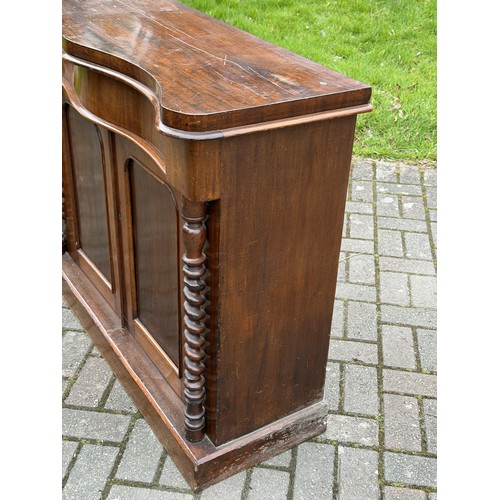 4092 - A 19th Century serpentine top cabinet over 1 long drawer and 2 panel doors, barley twist supports, 1... 