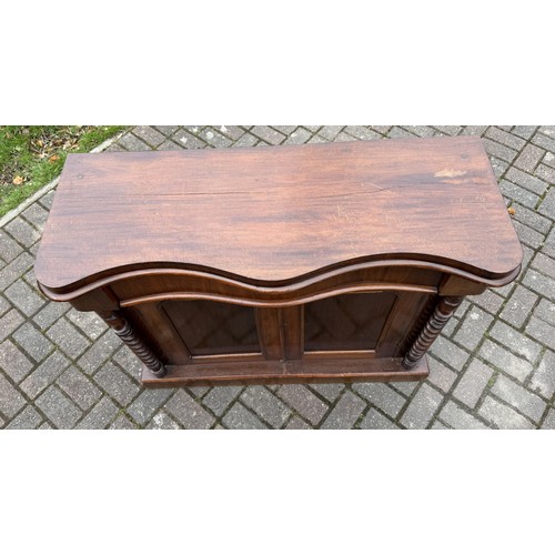 4092 - A 19th Century serpentine top cabinet over 1 long drawer and 2 panel doors, barley twist supports, 1... 