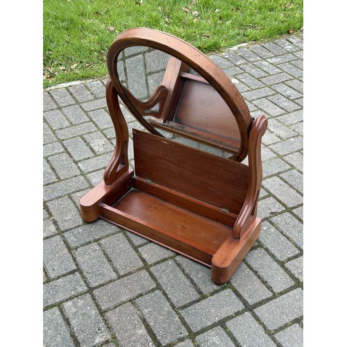 4093 - A 19th Century walnut oval swing toilet mirror with hinged top and on bun feet, 61.5cm wide, 28cm de... 