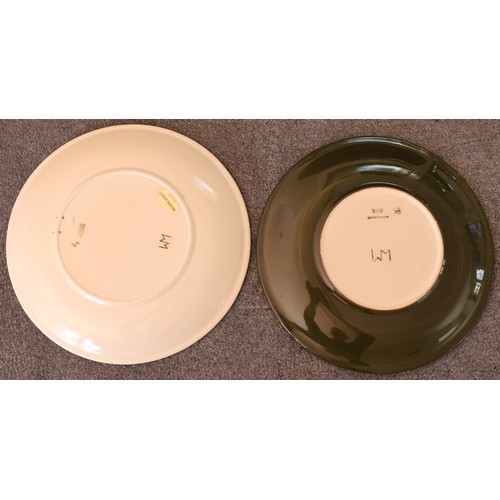91 - 2 Moorcroft round plates on cream and green ground with coloured floral and leaf decoration, 26.5cm ... 