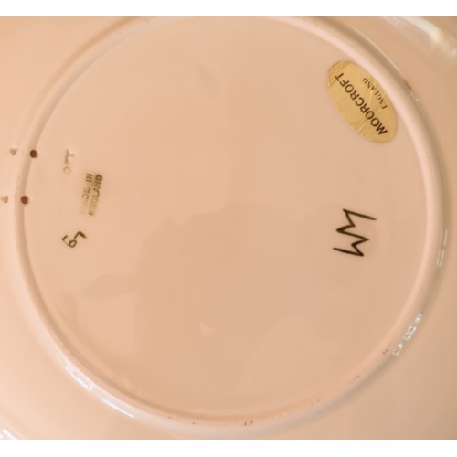 91 - 2 Moorcroft round plates on cream and green ground with coloured floral and leaf decoration, 26.5cm ... 