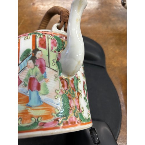 89 - A Cantonese round teapot with cover, wicker overhead handle, allover figure, bird, butterfly, floral... 