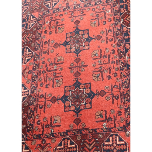 A small rug on red ground with 2 centre medallions, 158cm long, 102cm ...