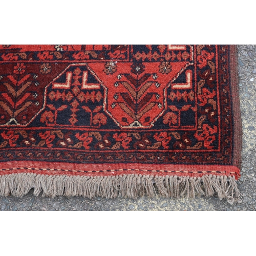 A small rug on red ground with 2 centre medallions, 158cm long, 102cm ...
