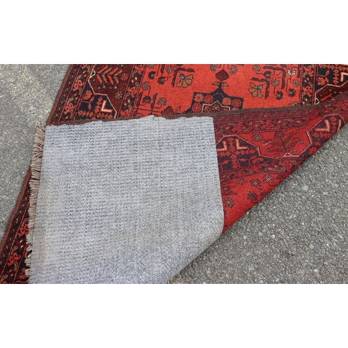 A small rug on red ground with 2 centre medallions, 158cm long, 102cm ...