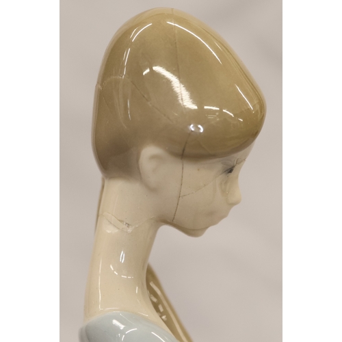 37 - 2 Lladro figurines; a Dutch boy carrying pails, 22cm high and a young girl holding a lamb, 27cm high... 