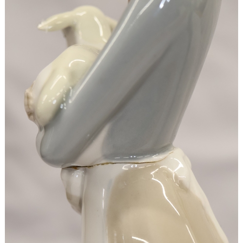 37 - 2 Lladro figurines; a Dutch boy carrying pails, 22cm high and a young girl holding a lamb, 27cm high... 