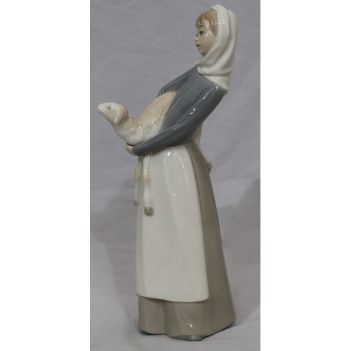 96 - A Lladro figure of a standing young lady holding a lamb, 27cm high