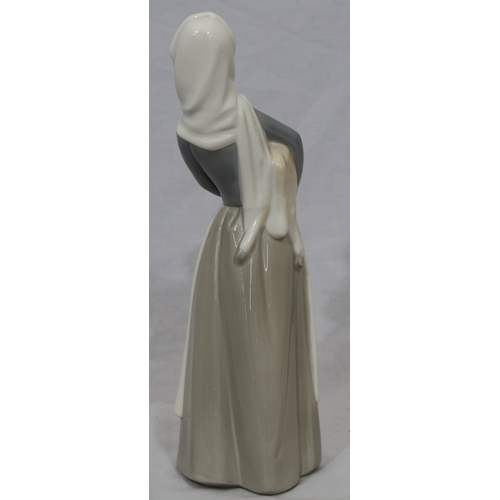 96 - A Lladro figure of a standing young lady holding a lamb, 27cm high