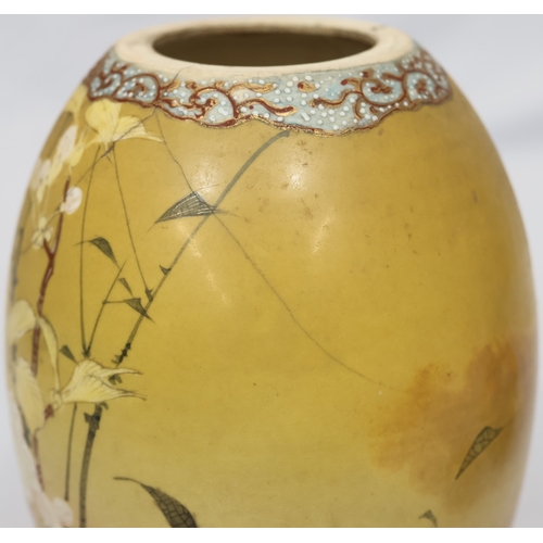 26 - A Satsuma round bulbous lidded ginger jar on yellow and red ground with bird, floral and bamboo deco... 