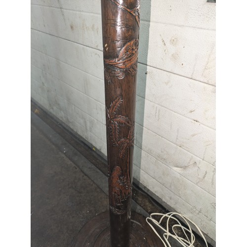 66 - An Ornate Freestanding Lamp With Various Carvings