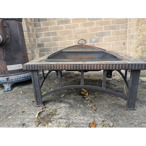 32 - A Metal Fire Pit With Tiled Surround