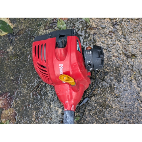 39 - A Homelite Mighty Light Petrol Strimmer