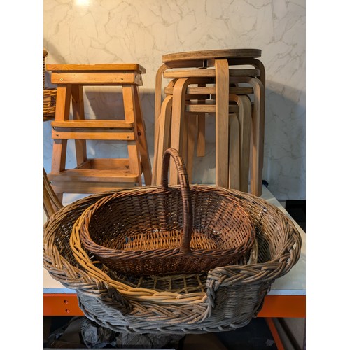 93 - a selection of 7 wooden stools and a variety of wicker baskets