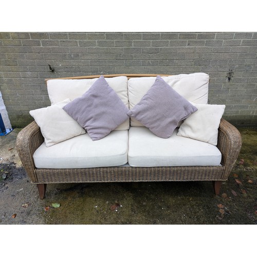 112 - A Leekes Wicker Conservatory Sofa With Pillows