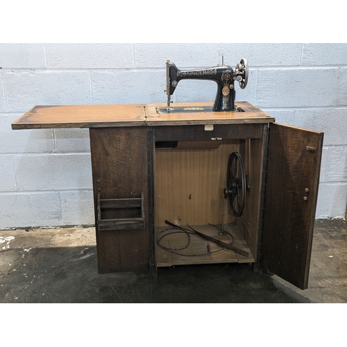 118 - A Singer 99K Foot Operable Sewing Machine In Cabinet