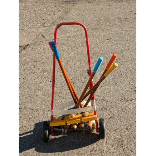 25 - A Set Of Croquet Mallets On A Wheeled Trolley