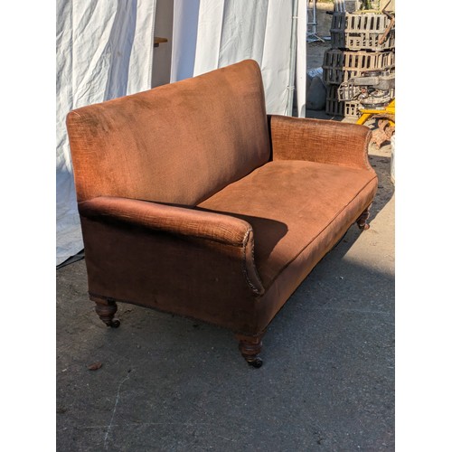 154 - A Victorian Brown Fabric Sofa With Castors