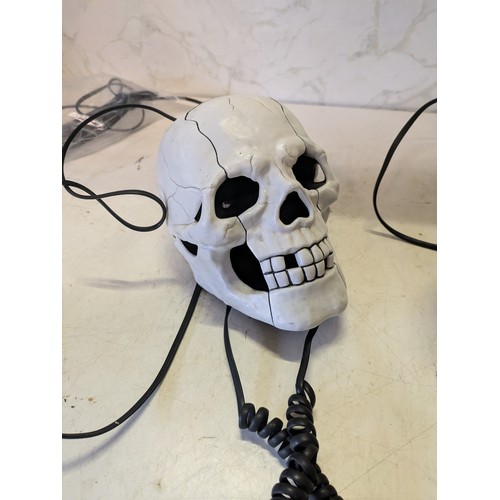 387 - a novelty skull telephone and a scooby doo telephone dancer