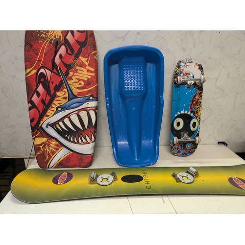 30 - a selection of various boards including skateboard, snowboard, body board and snow sled