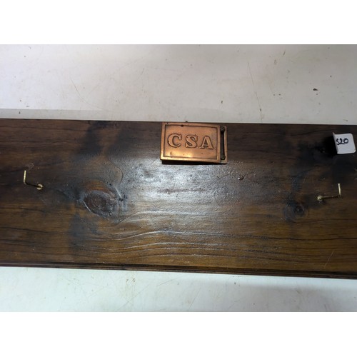 144 - a coat rack with a CSA belt buckle