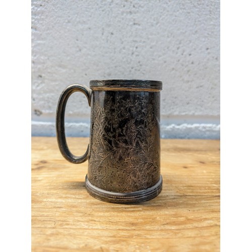 195 - An Antique Sterling Silver Tankard - London 1894 - floral pattern - approx 8cmx8cm inclusive of hand... 