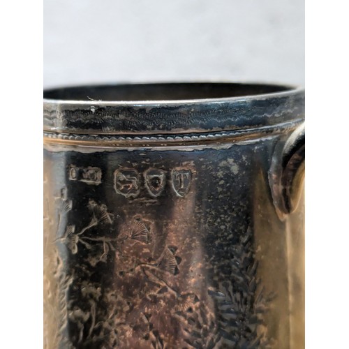 195 - An Antique Sterling Silver Tankard - London 1894 - floral pattern - approx 8cmx8cm inclusive of hand... 