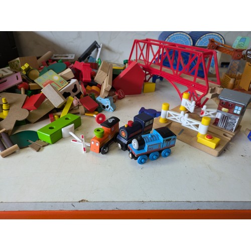 426 - a large selection of wooden train track with building, vehicles and characters