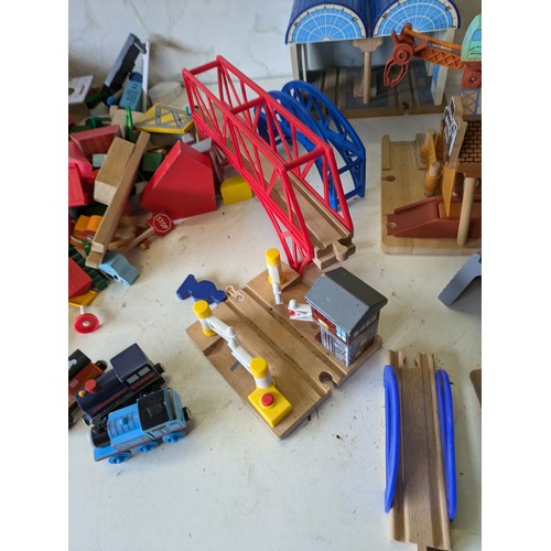 426 - a large selection of wooden train track with building, vehicles and characters