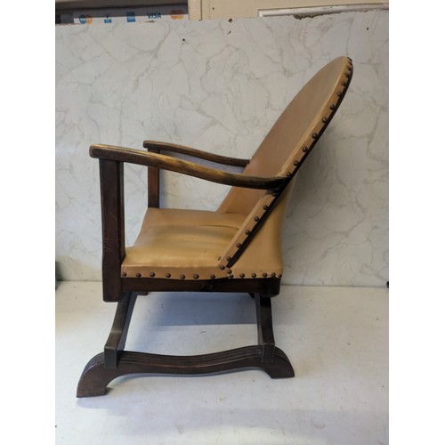 115 - a brown Wooden and leather studded chair