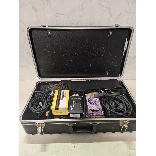 528 - a case containing a variety of guitar accessories