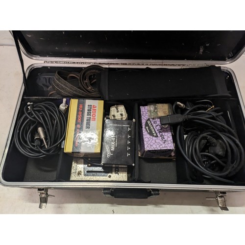 528 - a case containing a variety of guitar accessories