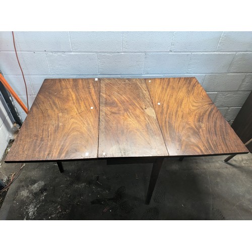 129 - an antique oak drop leaf table approx 145x73x94cm