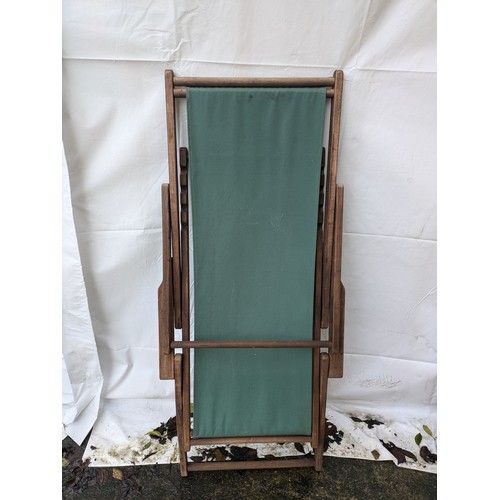 8 - a green fabric wooden deck chair