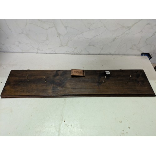 88 - a coat rack with a CSA belt buckle