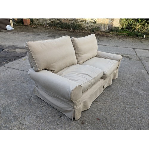 112 - A Cream 2 Seater Sofa With Covers