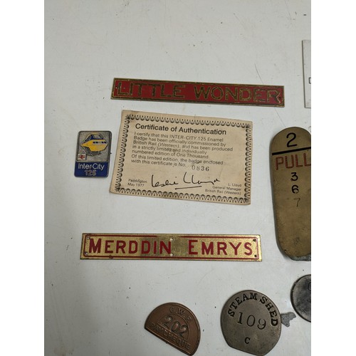 587 - A selection of train badges and signs