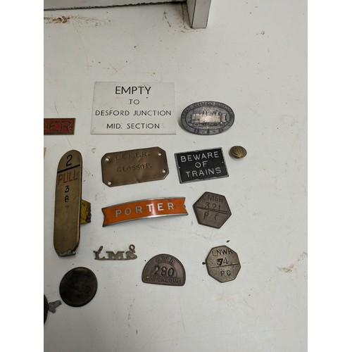 587 - A selection of train badges and signs