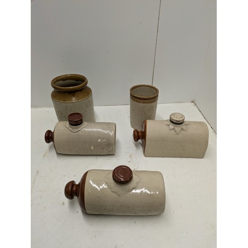 594 - A selection of stoneware jars and hot water bottles