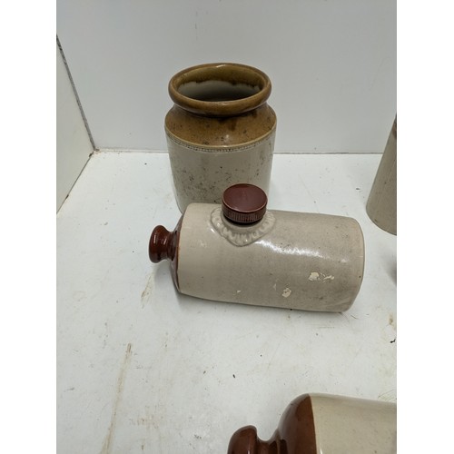 594 - A selection of stoneware jars and hot water bottles