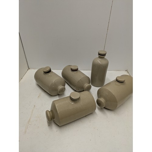 593 - A selection of stoneware jars and hot water bottles