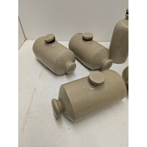 593 - A selection of stoneware jars and hot water bottles