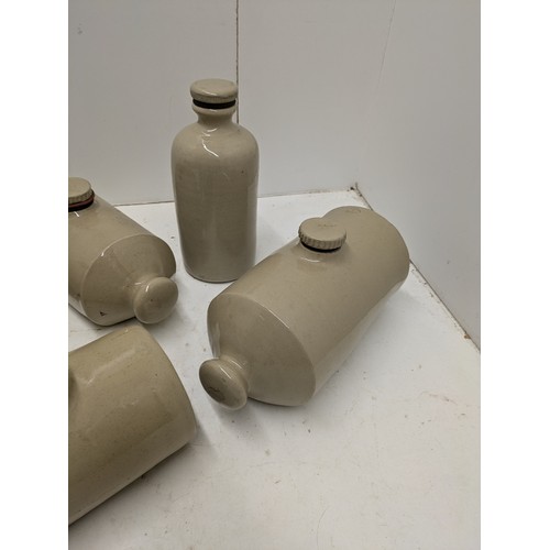 593 - A selection of stoneware jars and hot water bottles