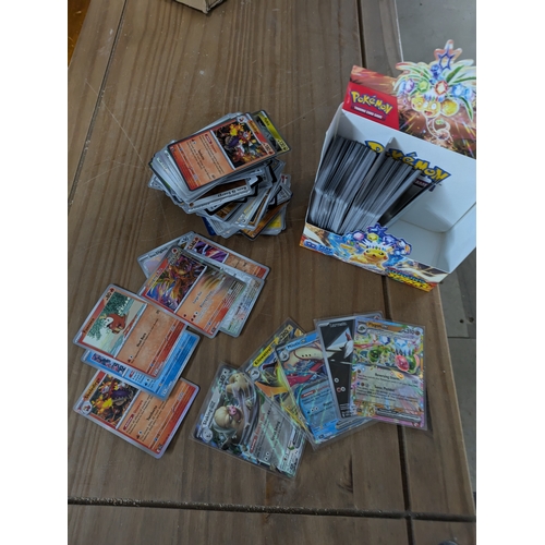 615 - A large quantity of Pokémon cards - some in protective sleeves - (surging sparks)