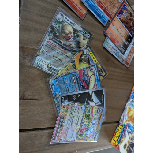 615 - A large quantity of Pokémon cards - some in protective sleeves - (surging sparks)