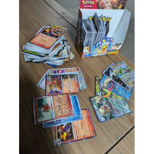 615 - A large quantity of Pokémon cards - some in protective sleeves - (surging sparks)