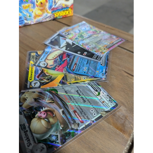 615 - A large quantity of Pokémon cards - some in protective sleeves - (surging sparks)