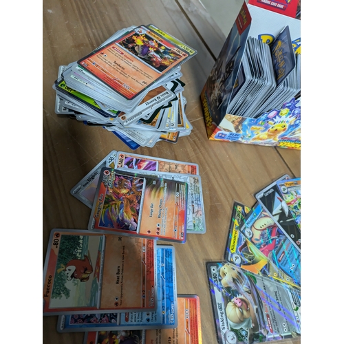 615 - A large quantity of Pokémon cards - some in protective sleeves - (surging sparks)